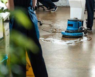 A cleaner using an industrial machine to clean an office floor