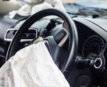A steering wheel with a deployed airbag