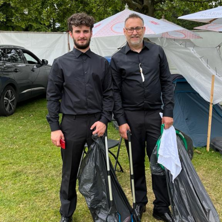 Cleaners holding litter pickers