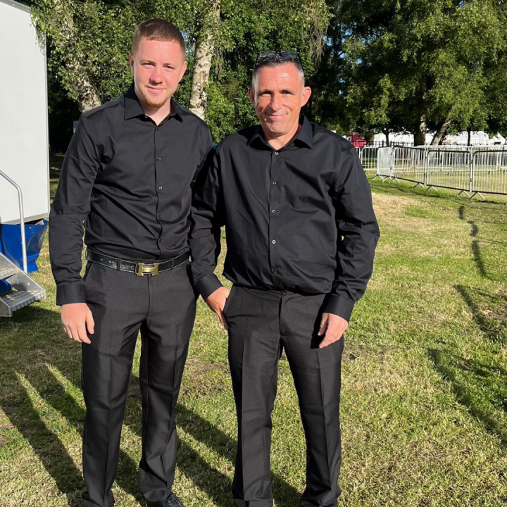 Cleaners wearing black, smart clothes