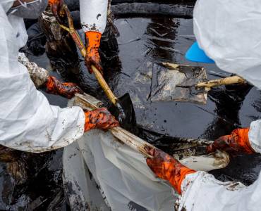 Specialist cleaners cleaning up an environmental spill