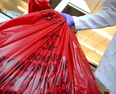 Some holding a biohazardous waste bag