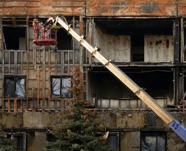 Building experts assess fire damage to a building.