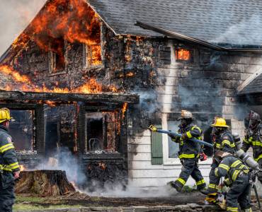 Firefighters extinguishing a house fire