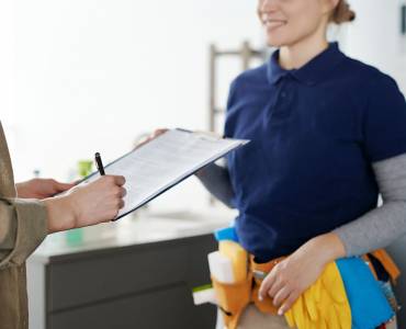 Contract cleaner signing contract with a client