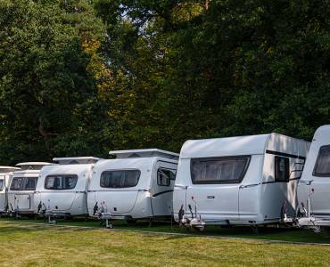 A line of campervans in a holiday park