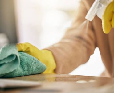 Someone cleaning a surface
