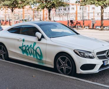 Green graffiti sprayed onto a white vehicle