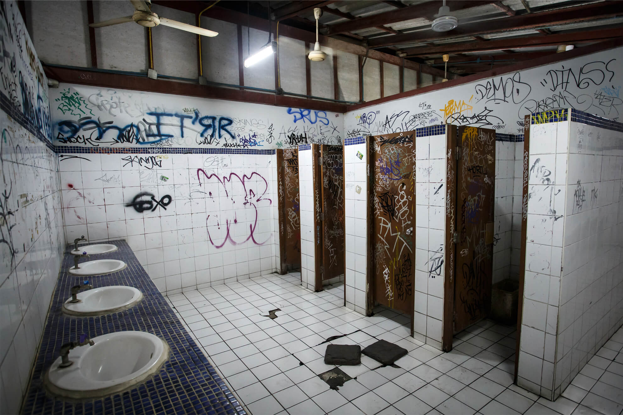 Vandalised toilets with graffiti covering the walls