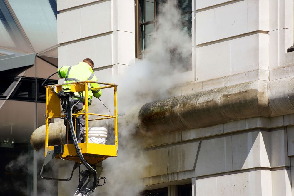 Facade cleaning using cherry picker