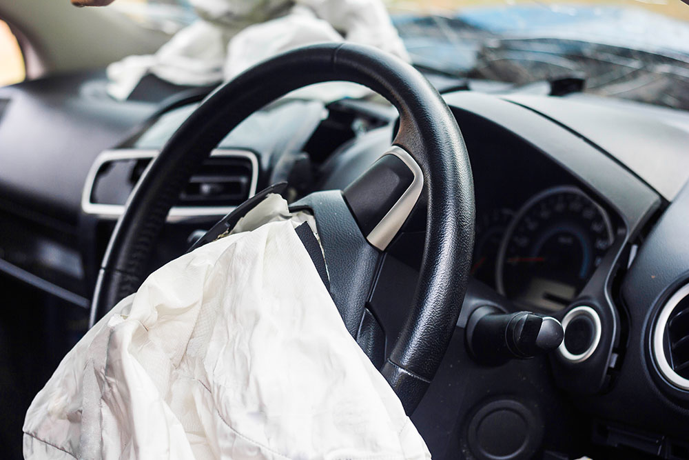 A steering wheel with a deployed airbag