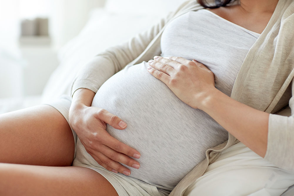 Pregnant woman on the sofa at home