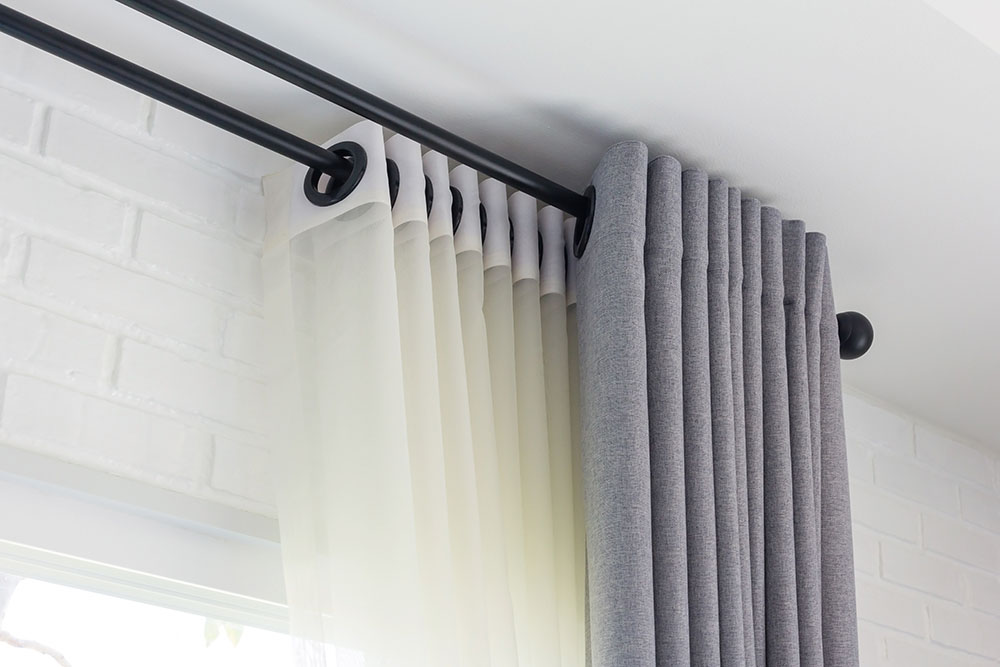 White and grey curtains with ring-top rail