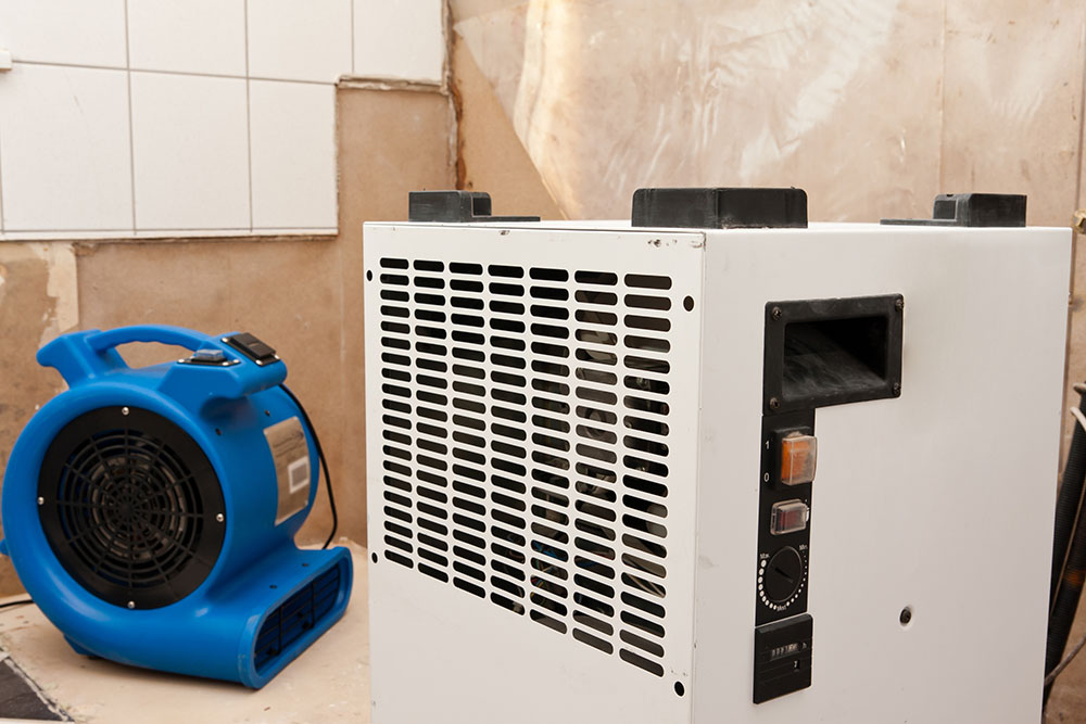 A dehumidifier and industrial fan for professional drying