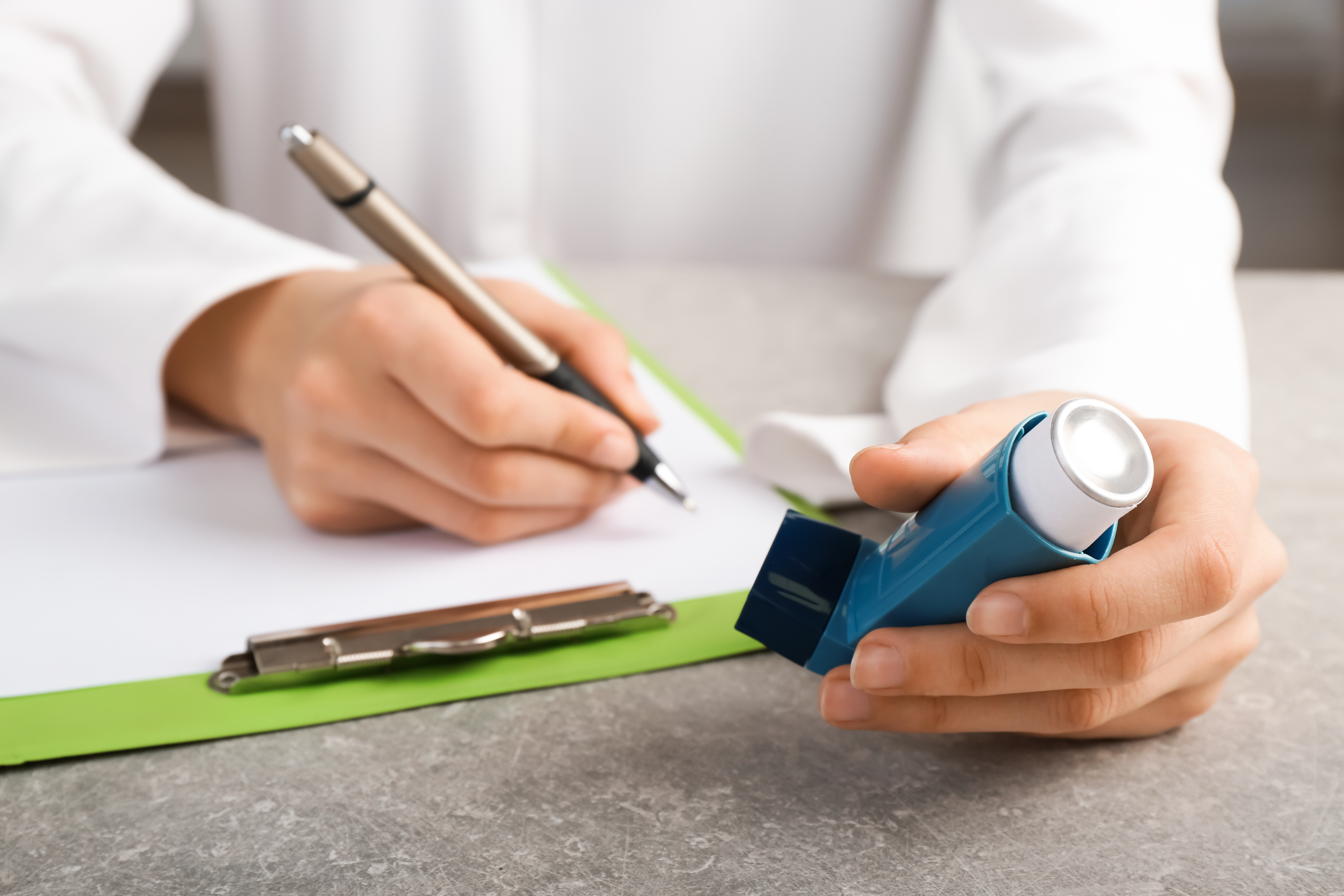 A doctor prescribing an inhaler