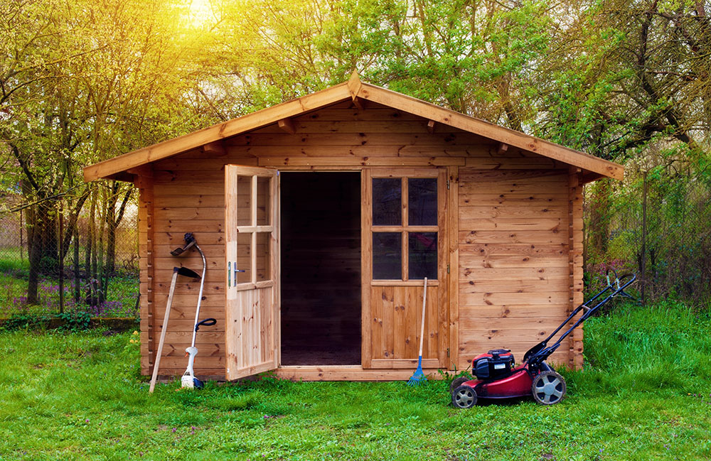 A wooden shed in a garden with the doors open