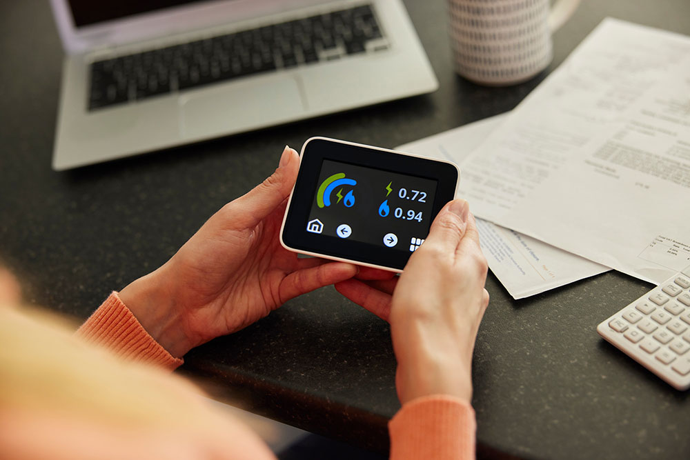 A woman holding an energy smart meter