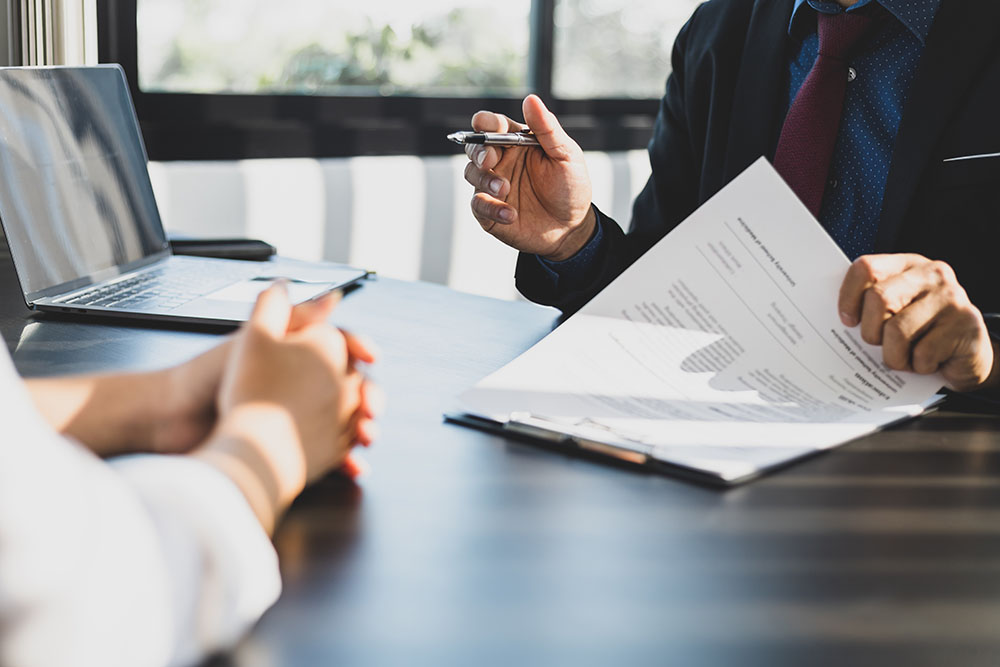 A solicitor and client signing paperwork