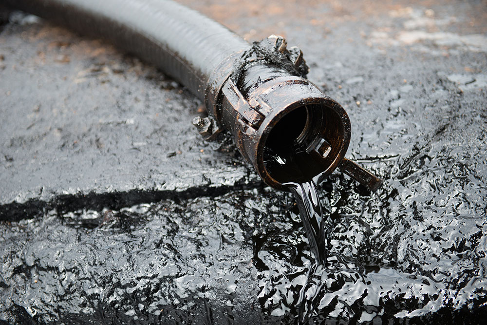 Crude oil spilling out of a pipe