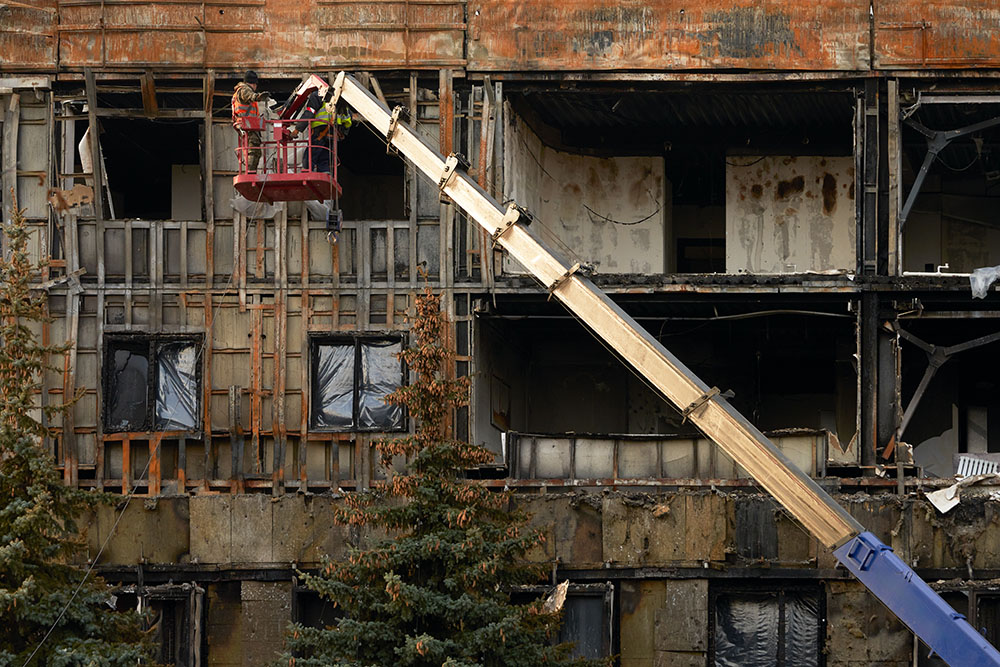 Building experts assess fire damage to a building.