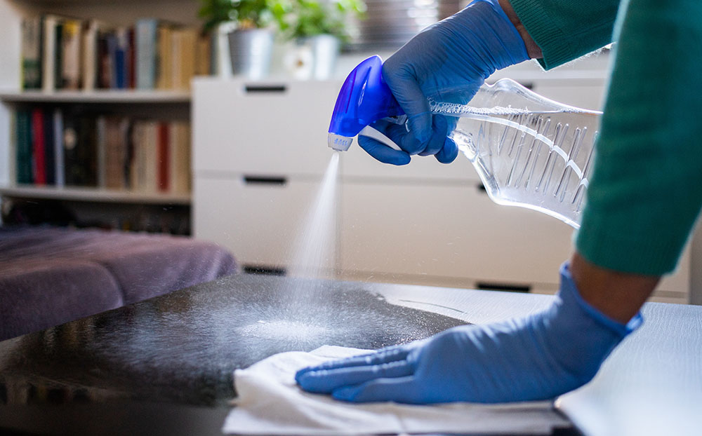 Cleaner spraying a surface