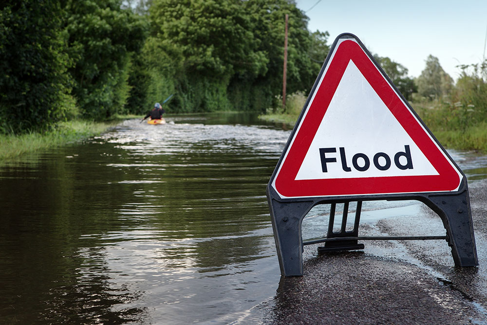 Flooded road with flood sign