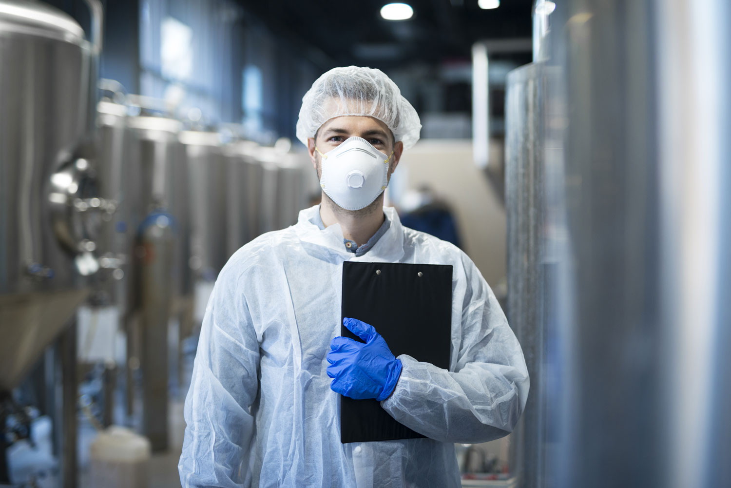 Man with clipboard in PPE