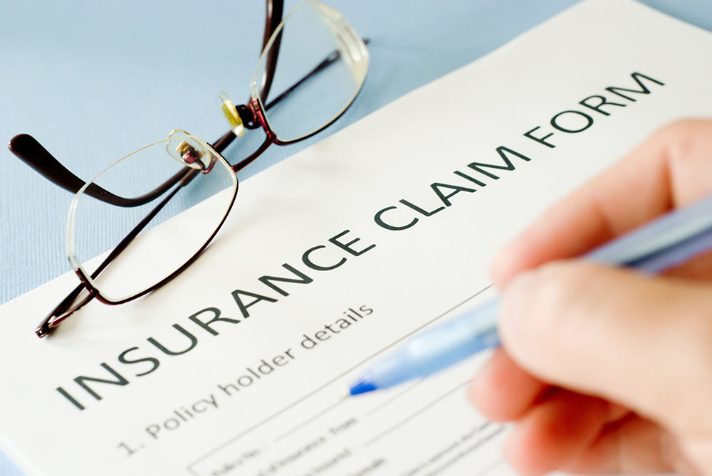 Insurance claim form being written on