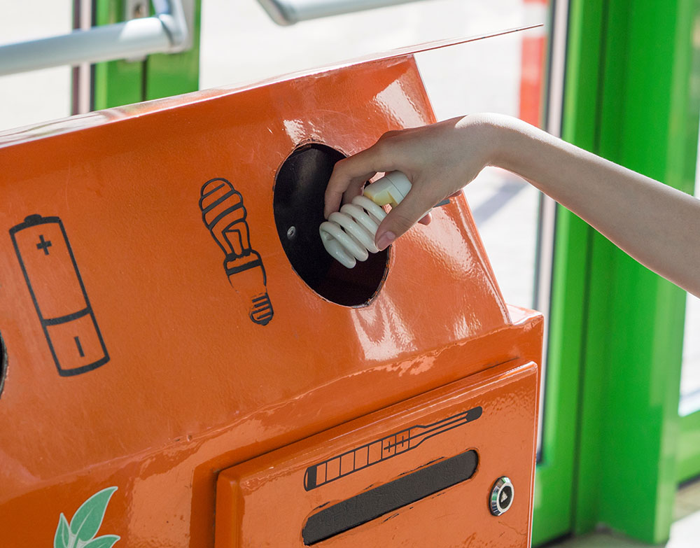 Woman disposing of mercury lightbulb