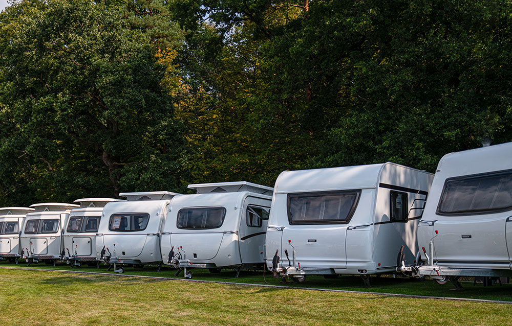 A line of campervans in a holiday park