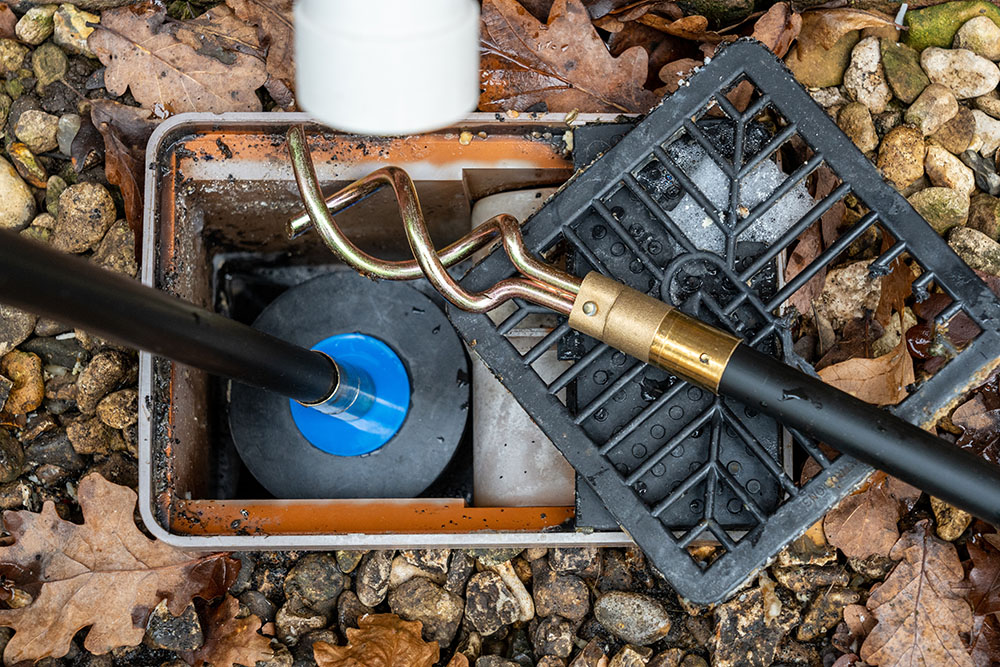 Outdoor drain being cleaned