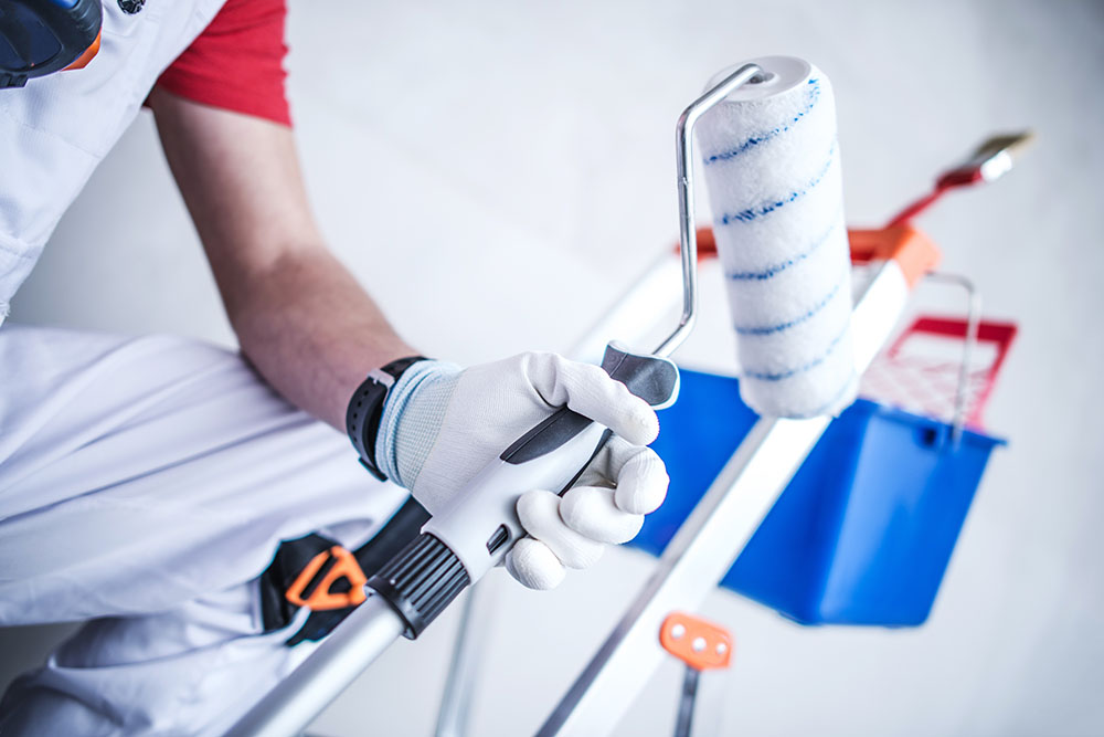 Painter preparing a paint roller