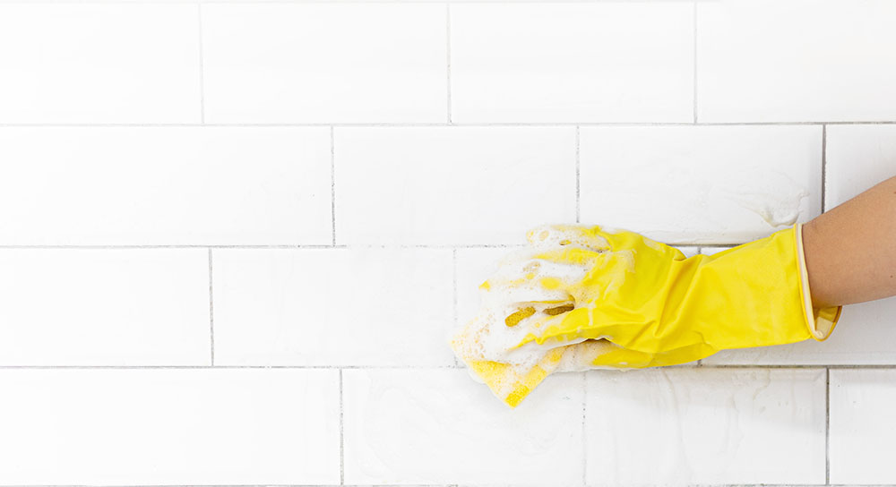 Someone cleaning white tiles