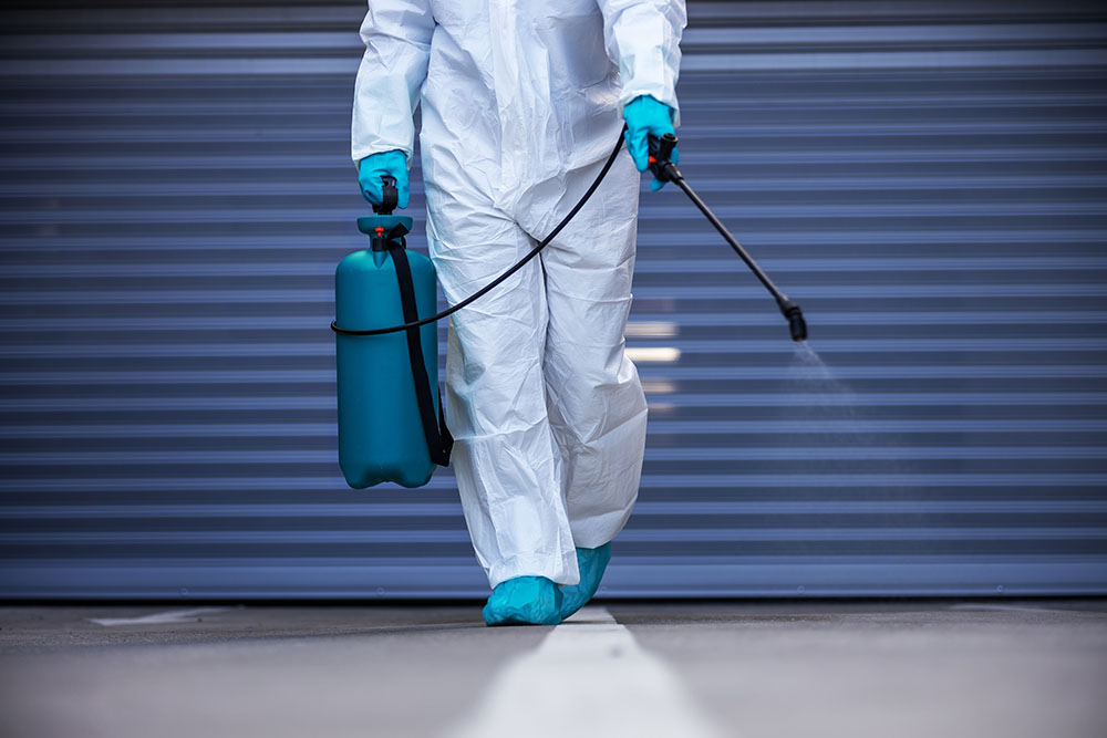 A trauma cleaner sanitising a floor