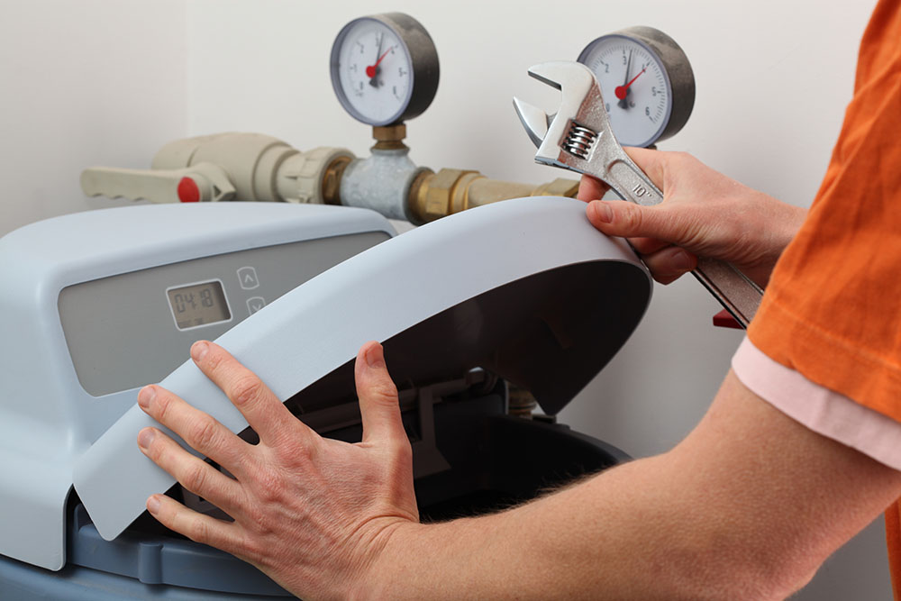 Man fitting a water softener