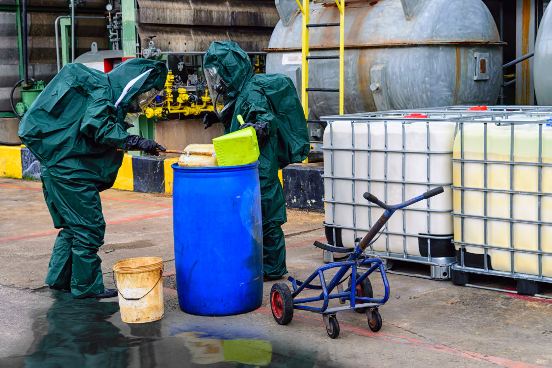 Two plant workers cleaning a chemical spill