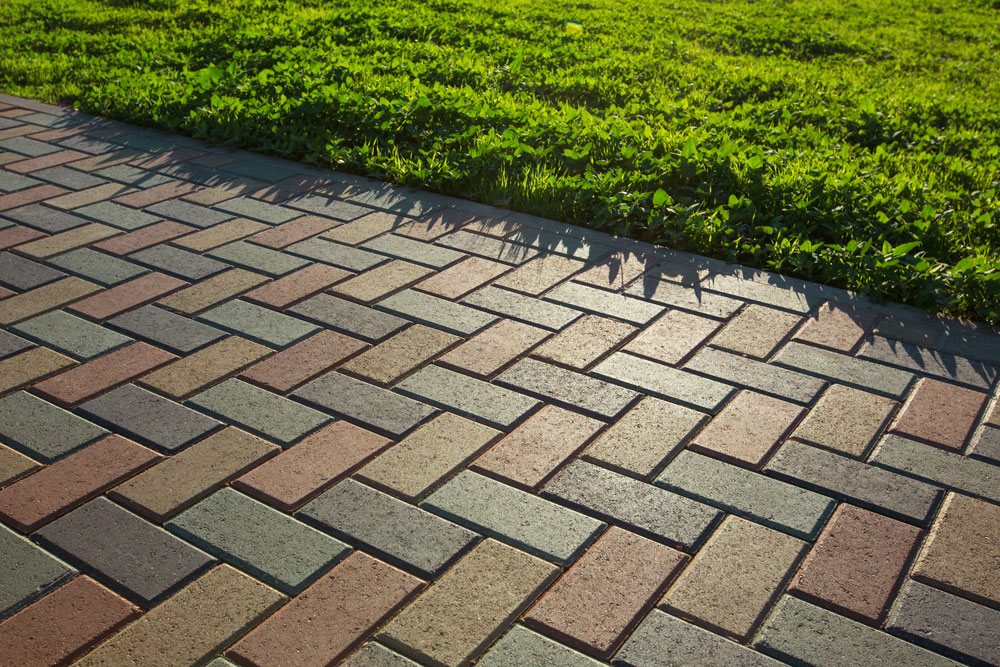 Brick driveway next to a lawn