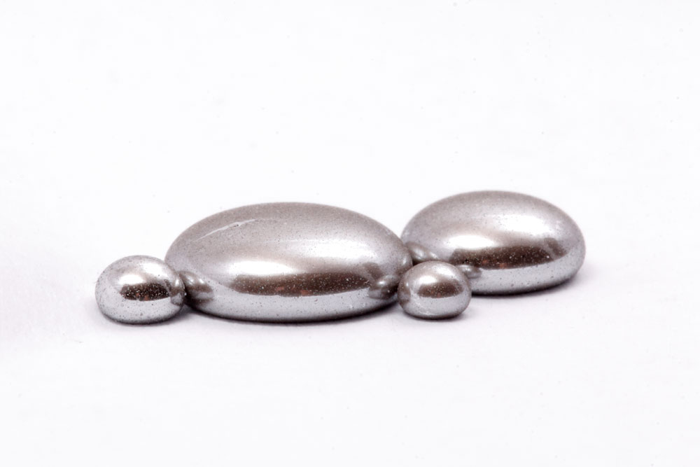 Beads of mercury on white background