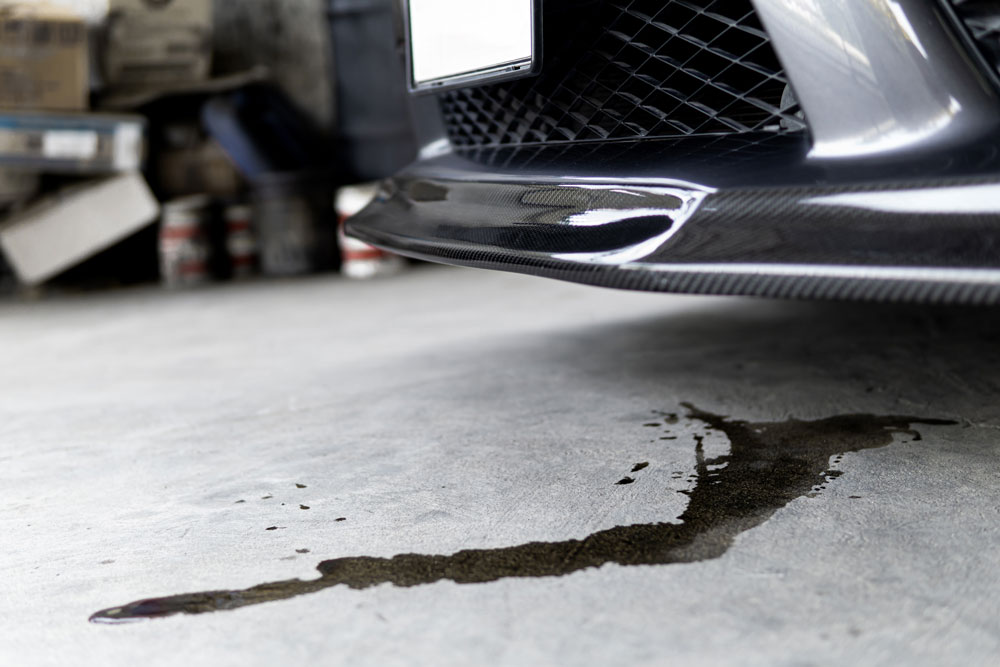 Oil leaking from car onto a garage floor
