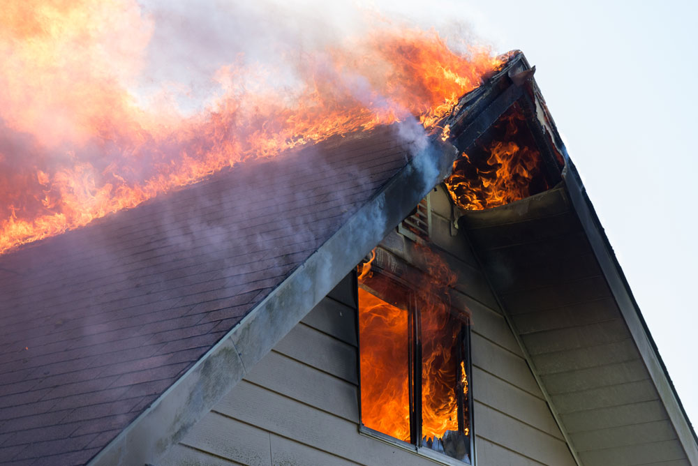 House fire coming through a window and the roof