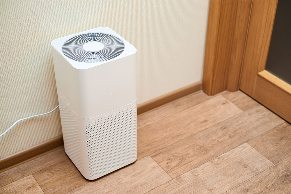 A white dehumidifier in an apartment