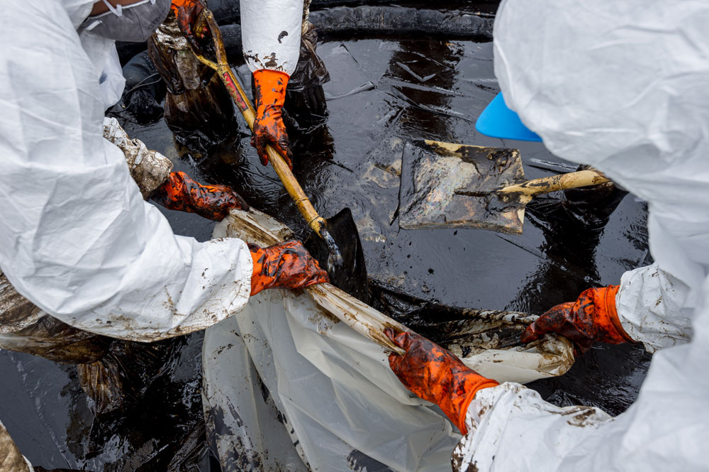 Specialist cleaners cleaning up an oil spill