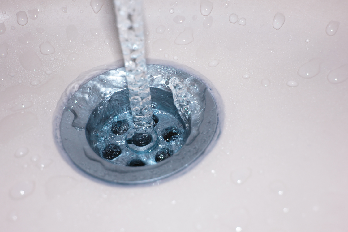 Water being poured down a drain