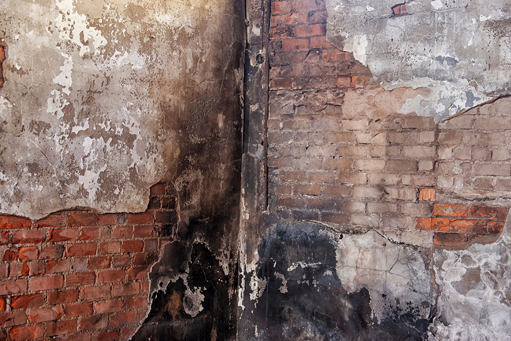 A fire-damaged brick wall