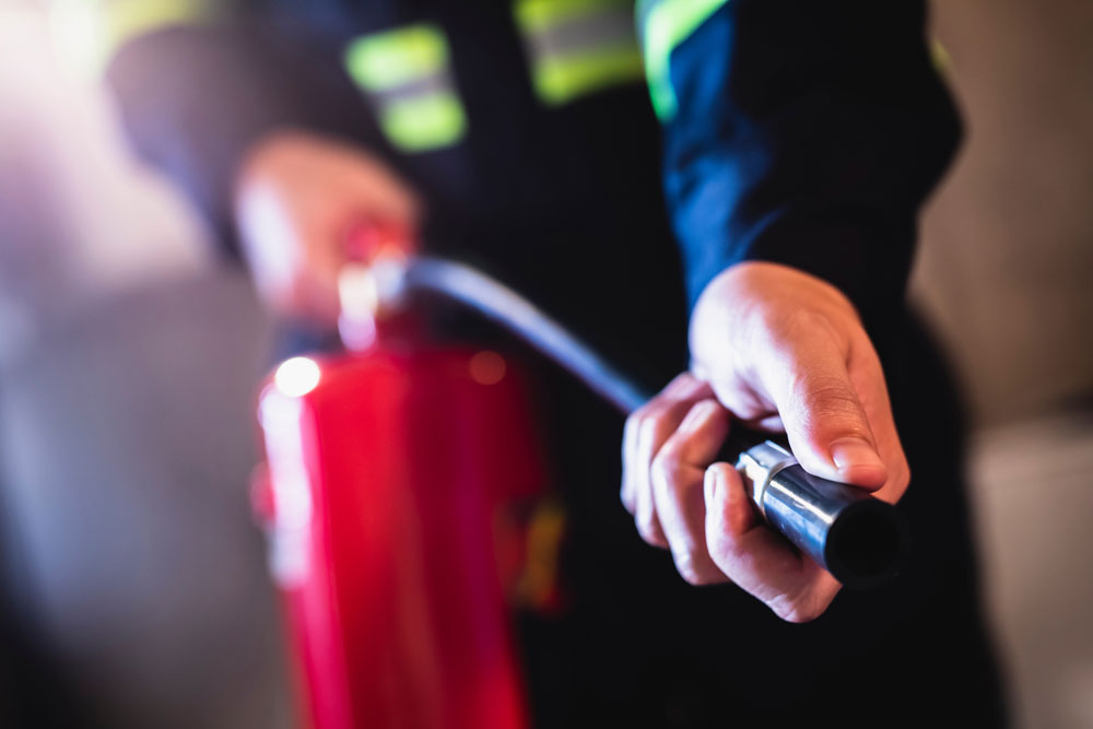 Fire fighter holding a fire extinguisher