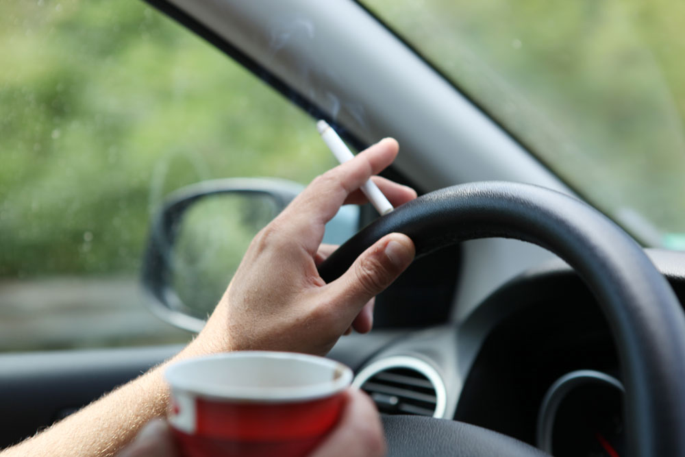 Smoking smoking while driving a car