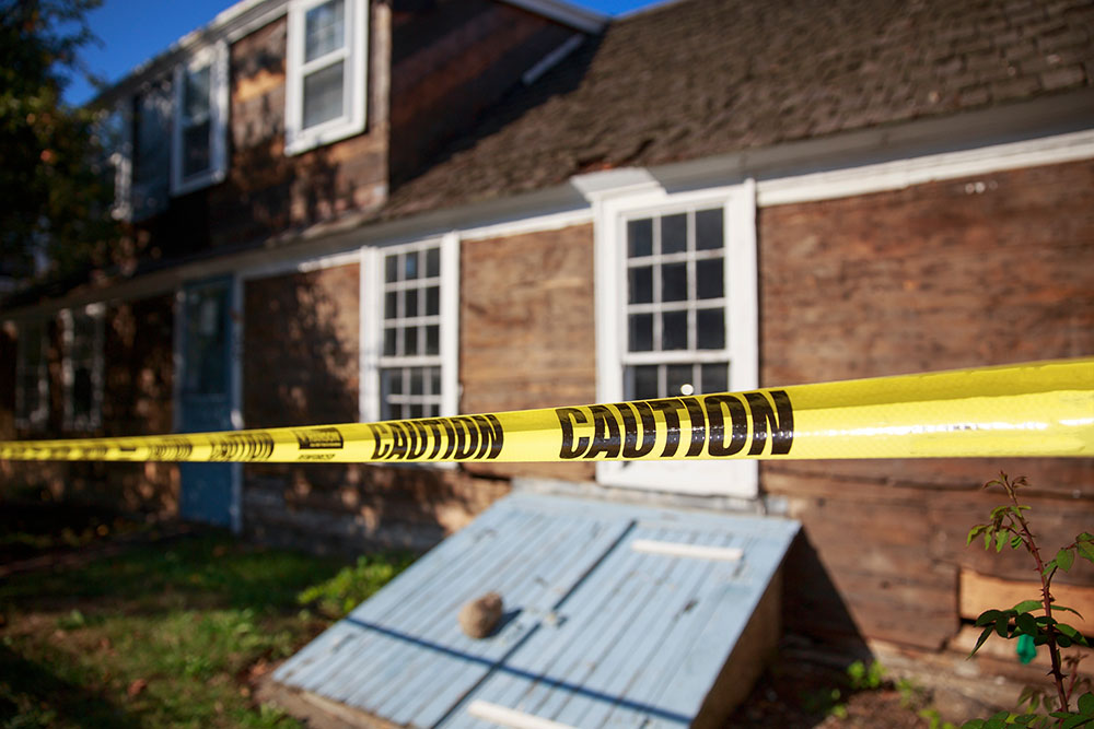 House with yellow tape in front of it