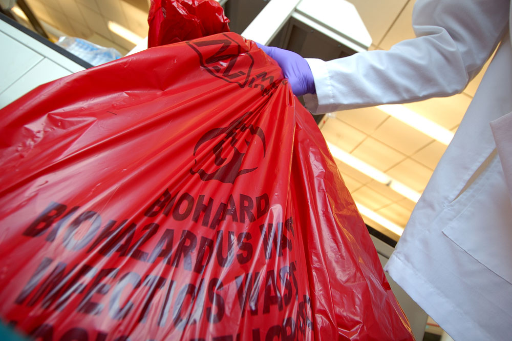 Someone holding a biohazardous waste bag