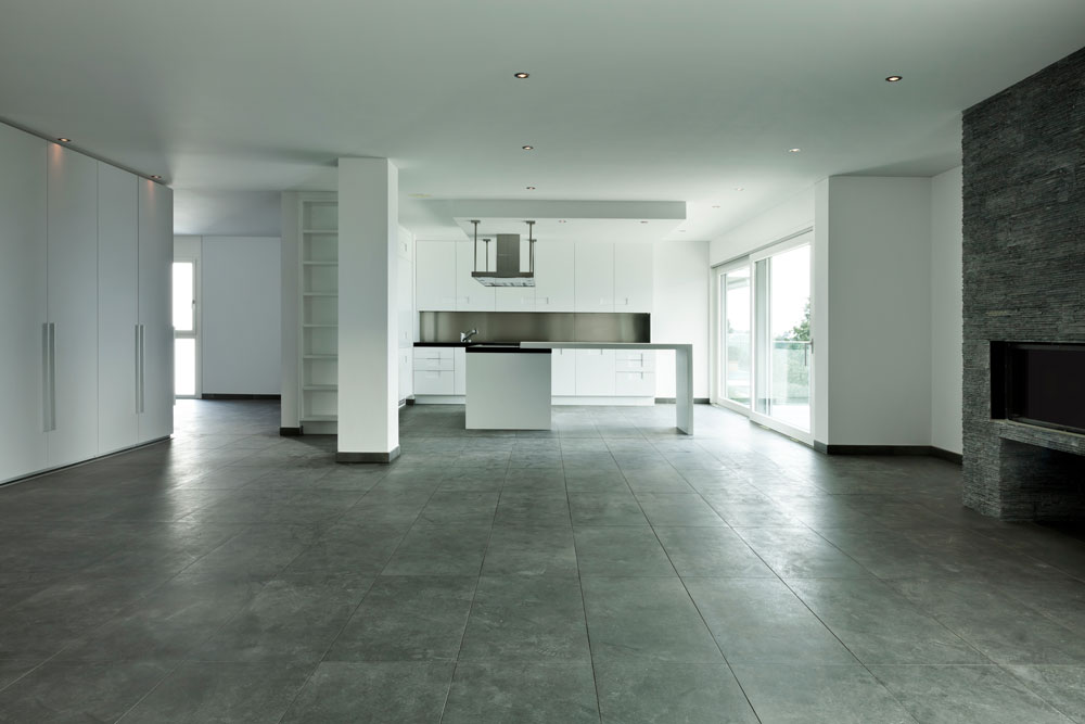 An empty kitchen with a stone floor