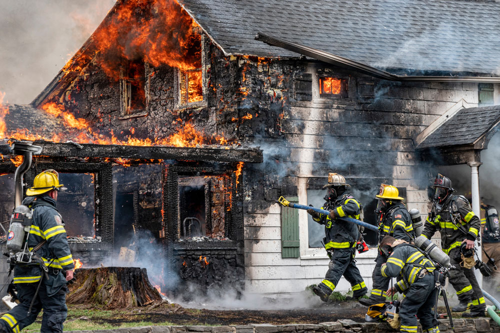 Firefighters extinguishing a house fire